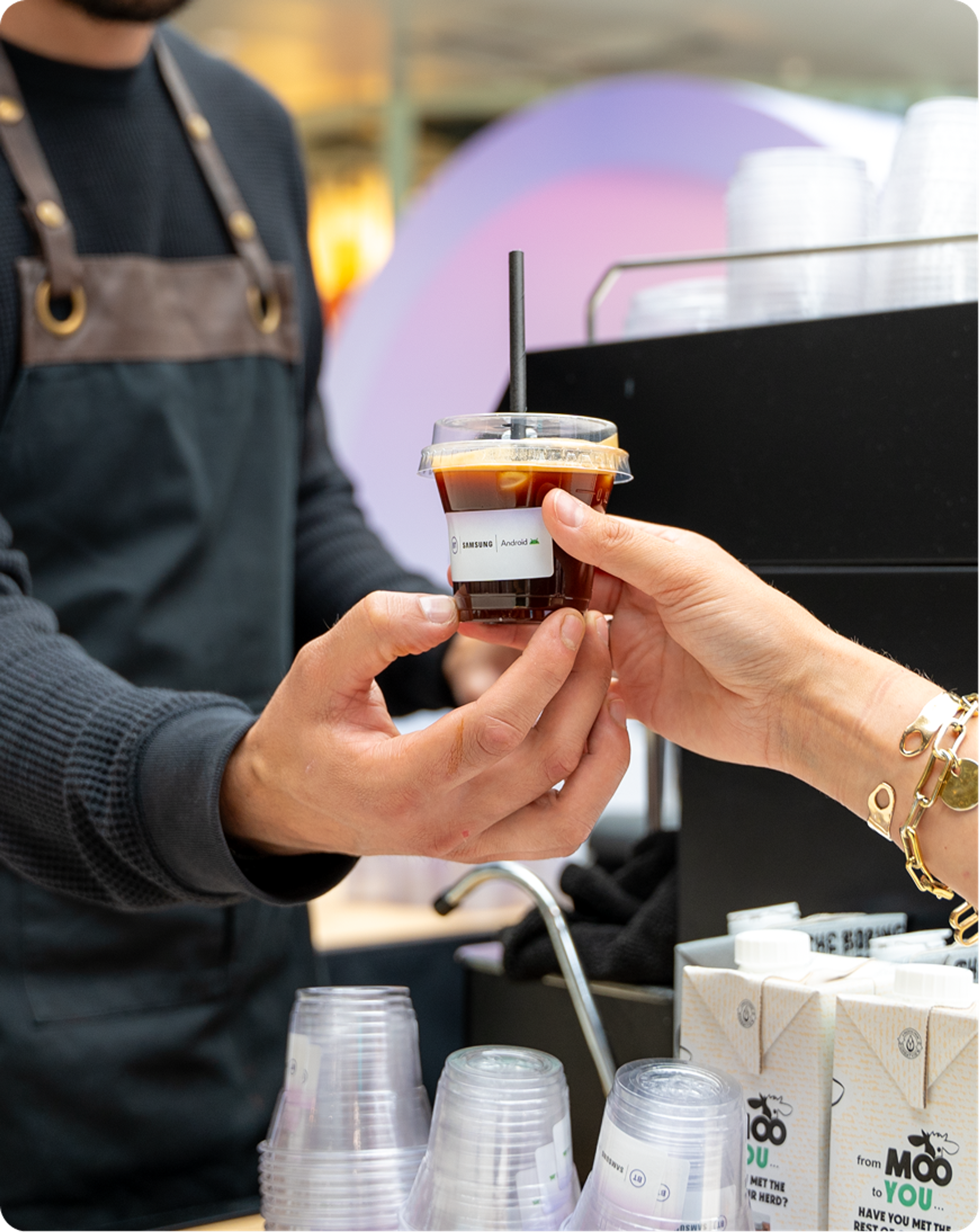 Branded coffee being handed to a visitor at the BT, Samsung and Android Enterprise activation