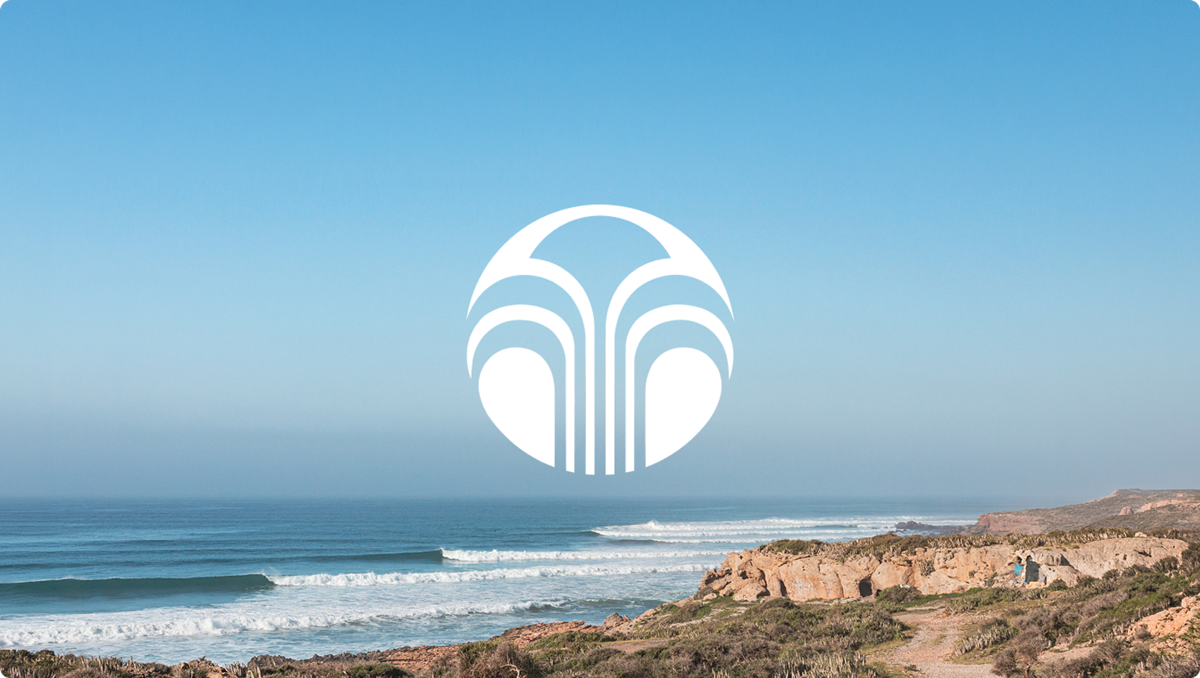 White Nu Skin logo over waves breaking along Morocco’s rocky coastline.