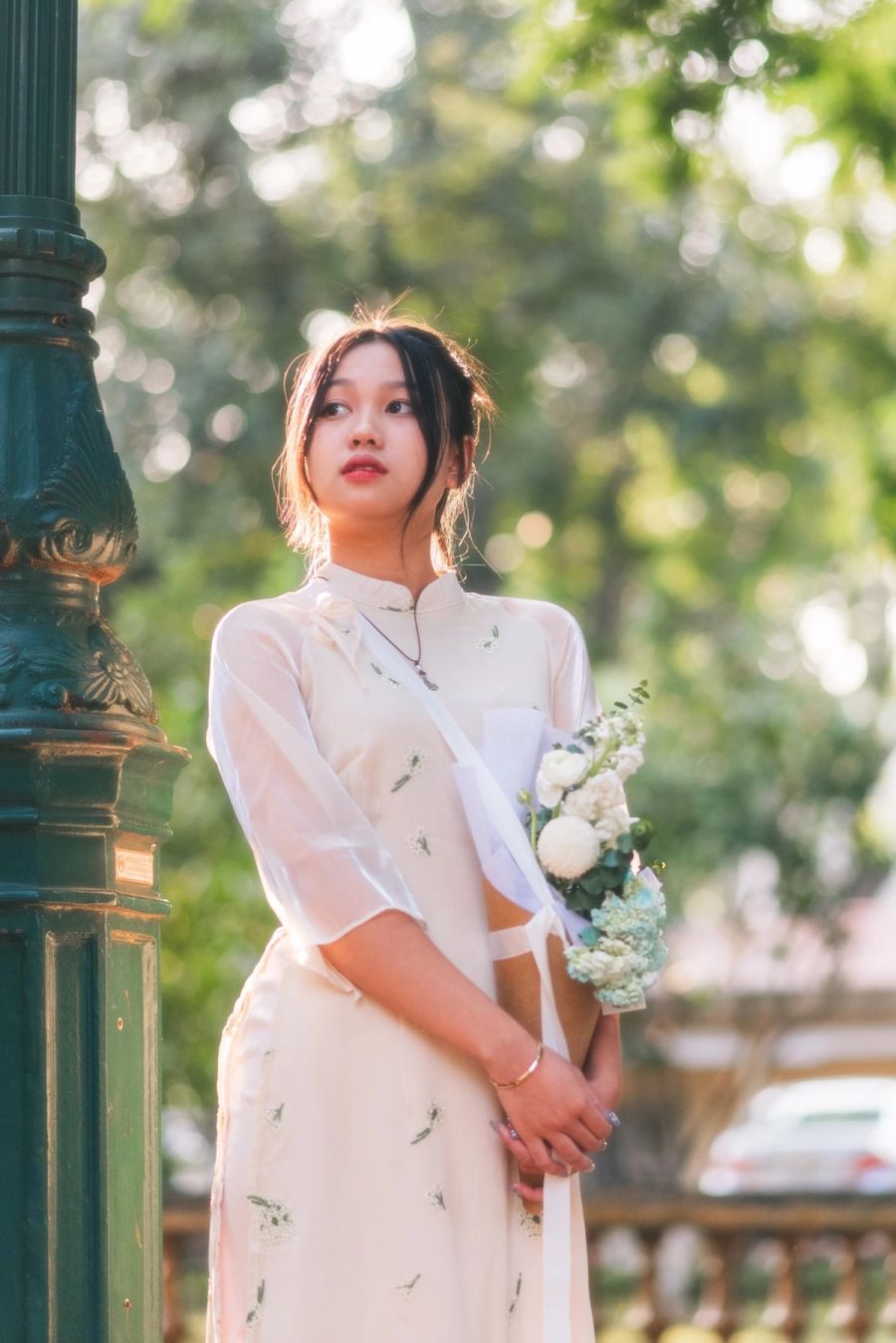 Bride in an embroidered dress holding a small bouquet