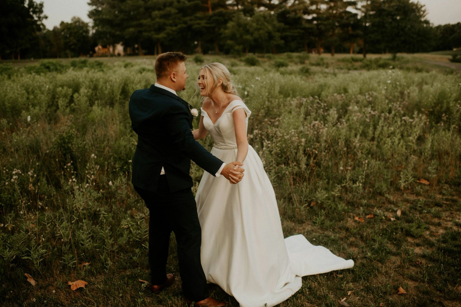 Newlyweds walking through a shower of rice in a wooden chapel