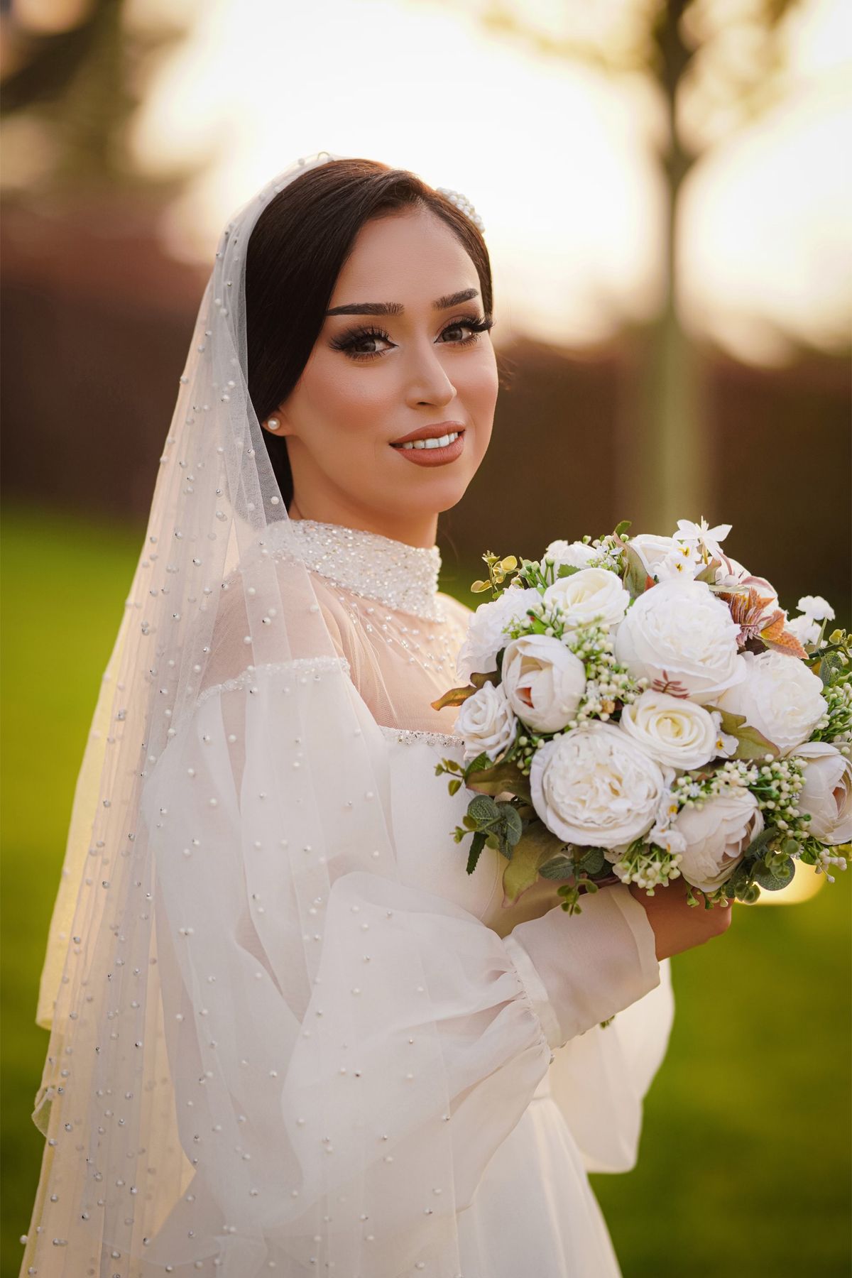Bride holding a white peony bouquet