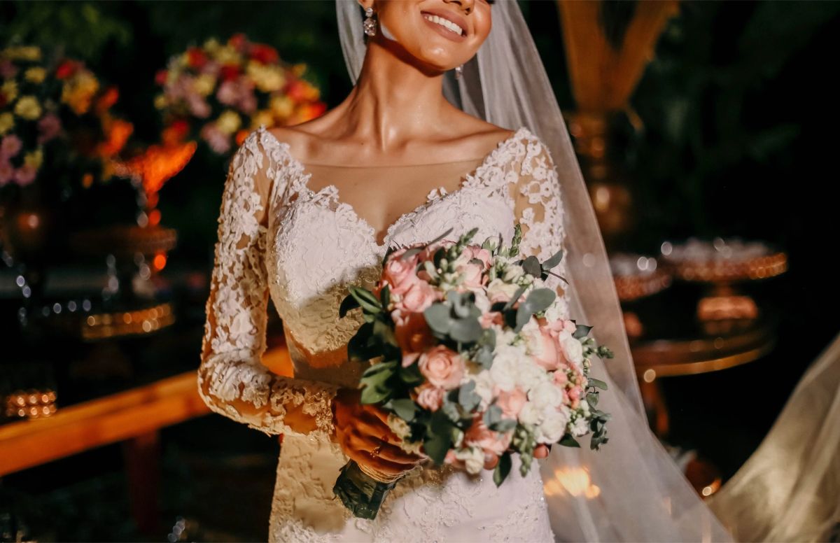 Bride holding her bouquet at a candlelit reception