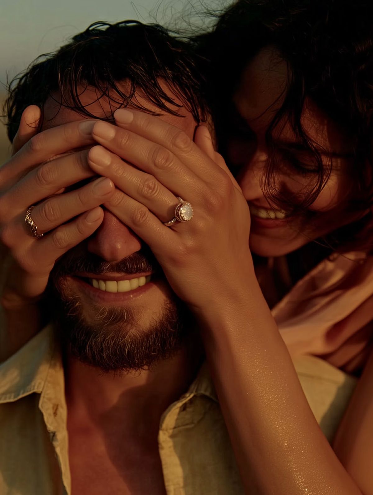 Groom covering his eyes while his bride laughs beside him