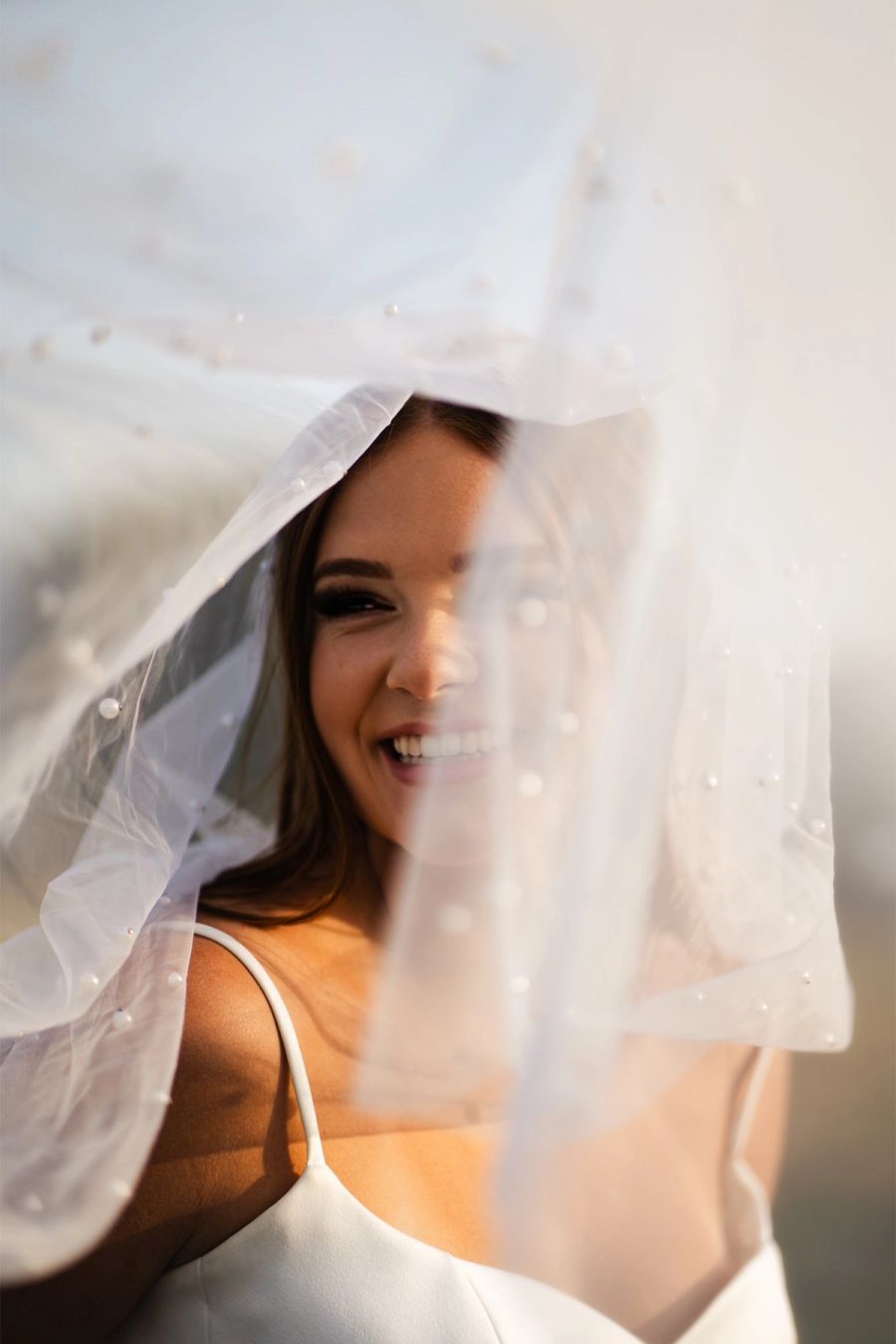 Portrait of Sara Pierce wearing a soft veil