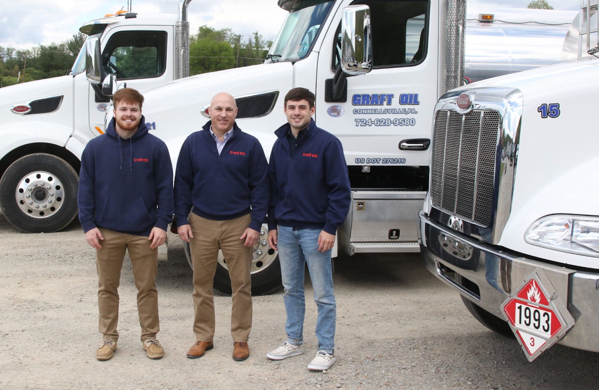 The Franks family in front of Graft Oil fuel trucks