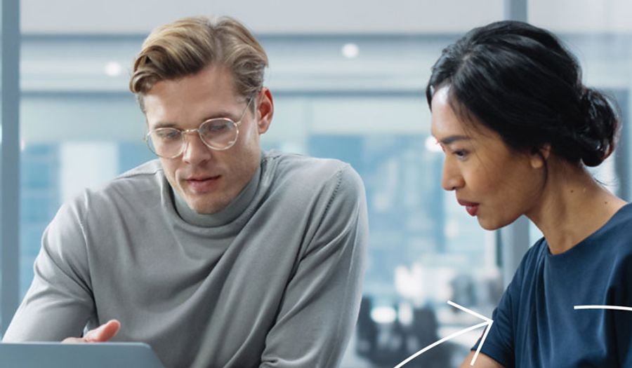 Two people looking at a computer