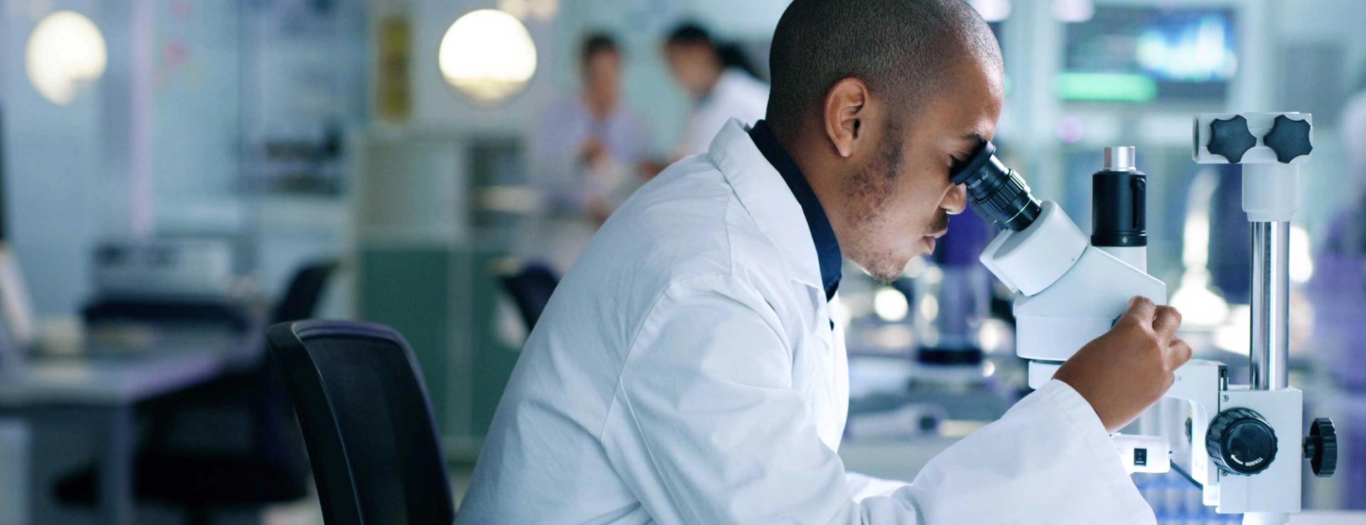 Scientist looking in microscope