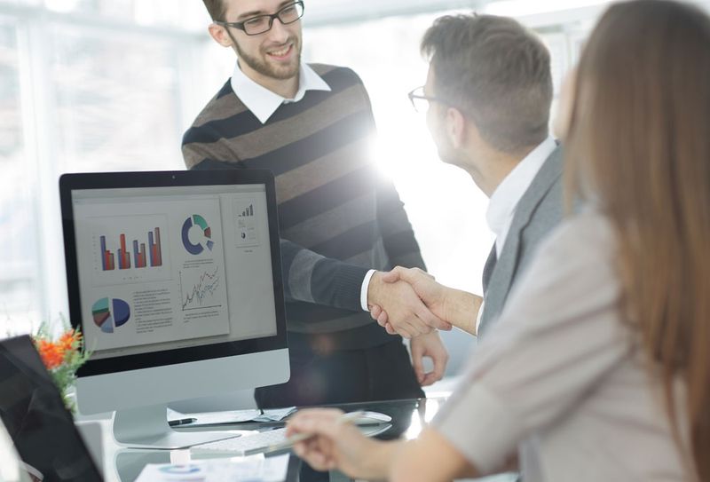 Office workers shaking hands