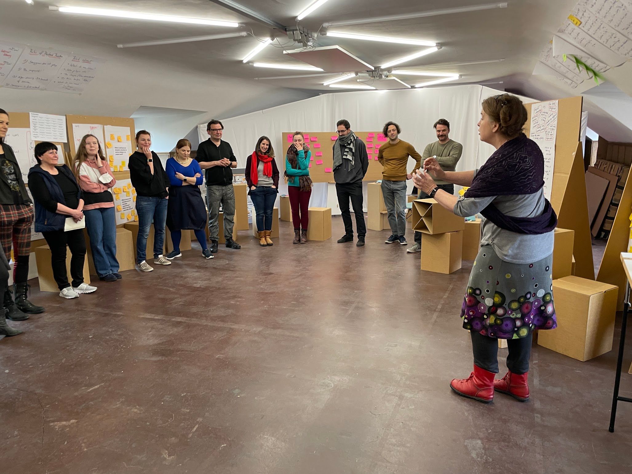 Johanna facilitating a workshop with a group standing in a semicircle