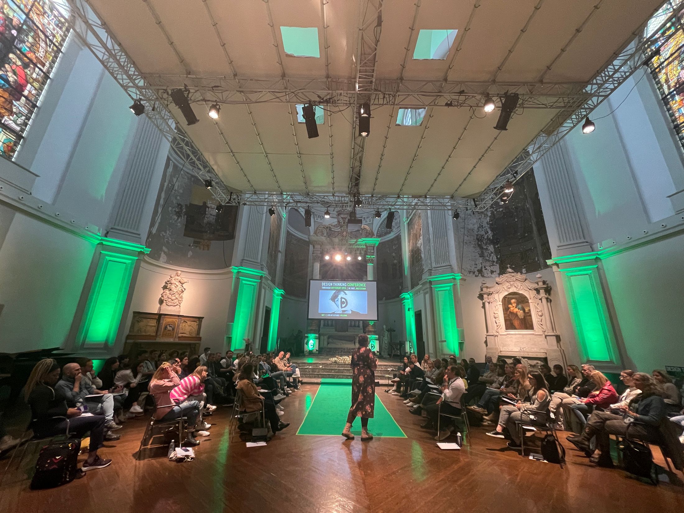 Johanna speaking at a conference in a converted church