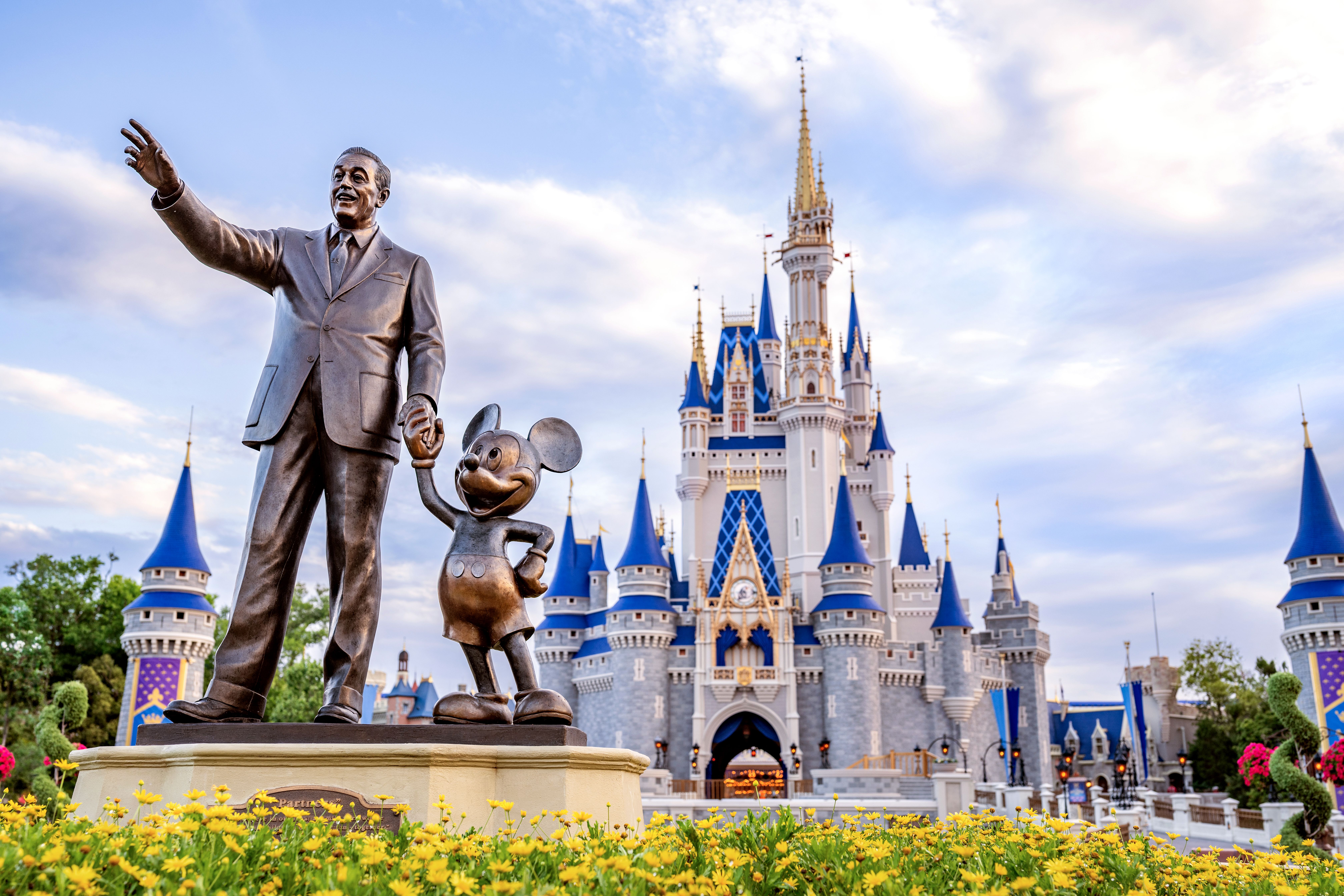 Statue of Walt and Mickey in front of the Castle