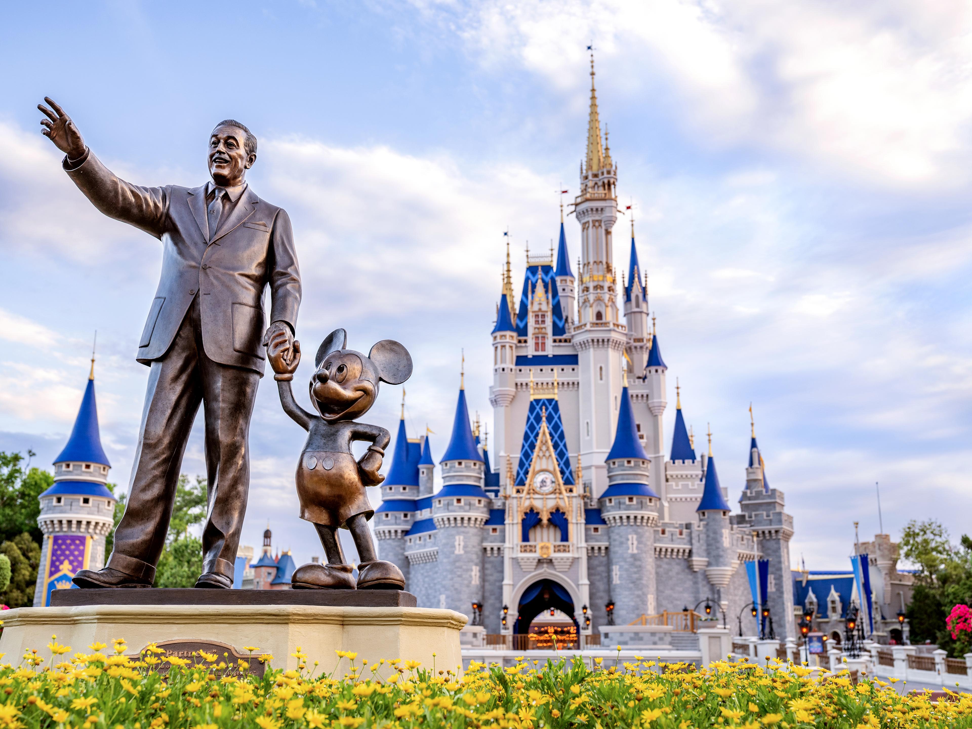 Statue of Walt and Mickey in front of the Castle