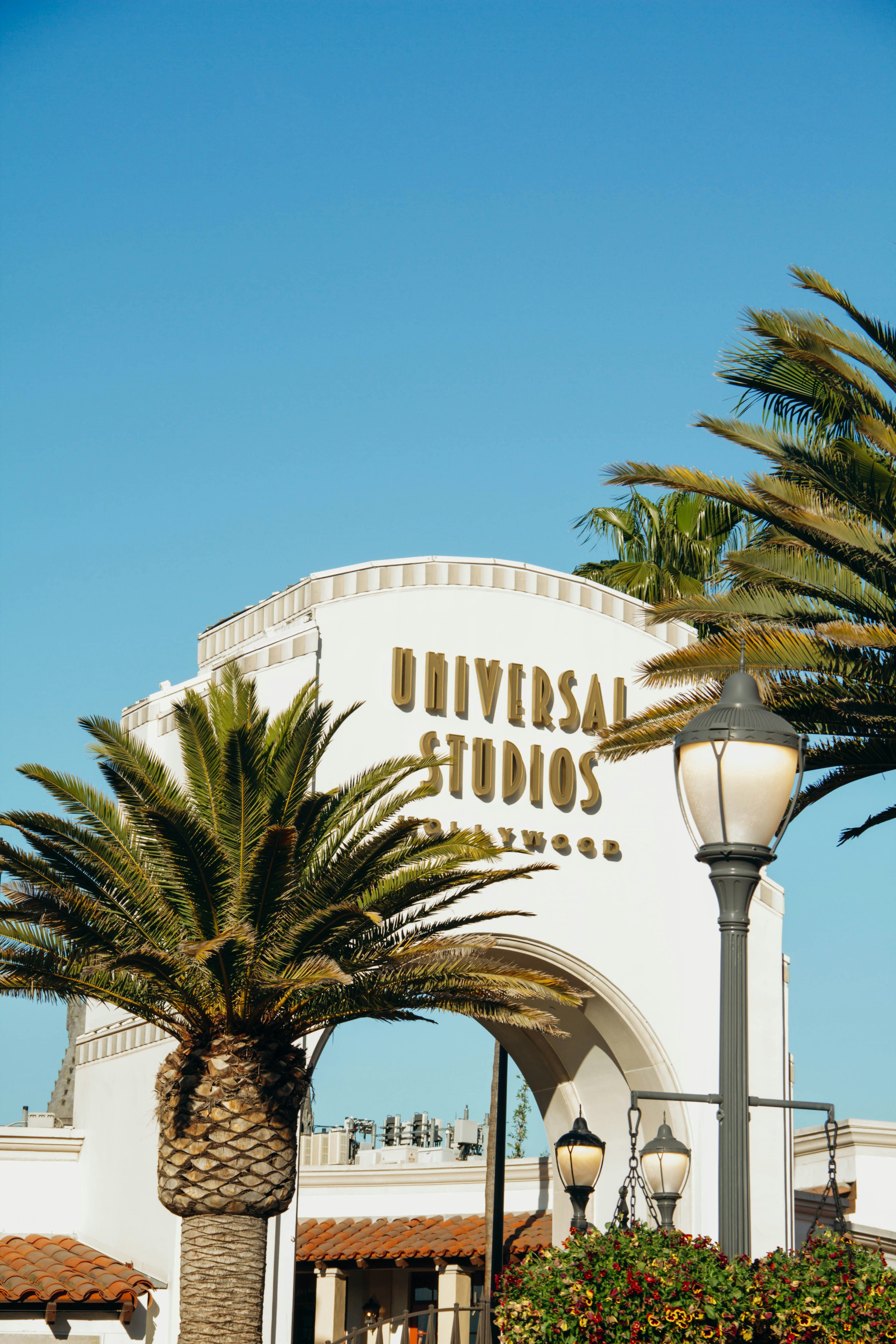 The Universal Studios Hollywood sign against the palm trees