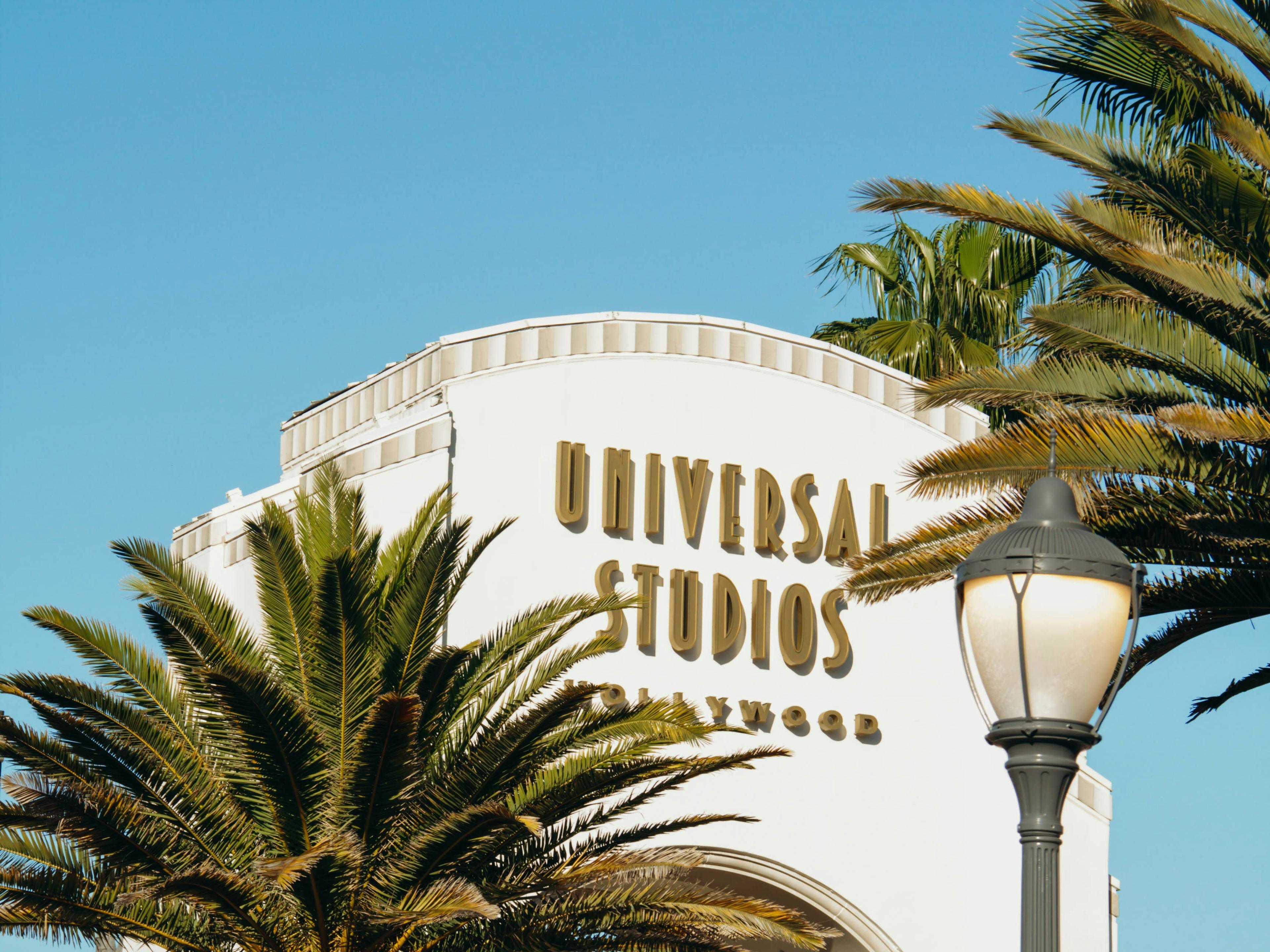 The Universal Studios Hollywood sign against the palm trees