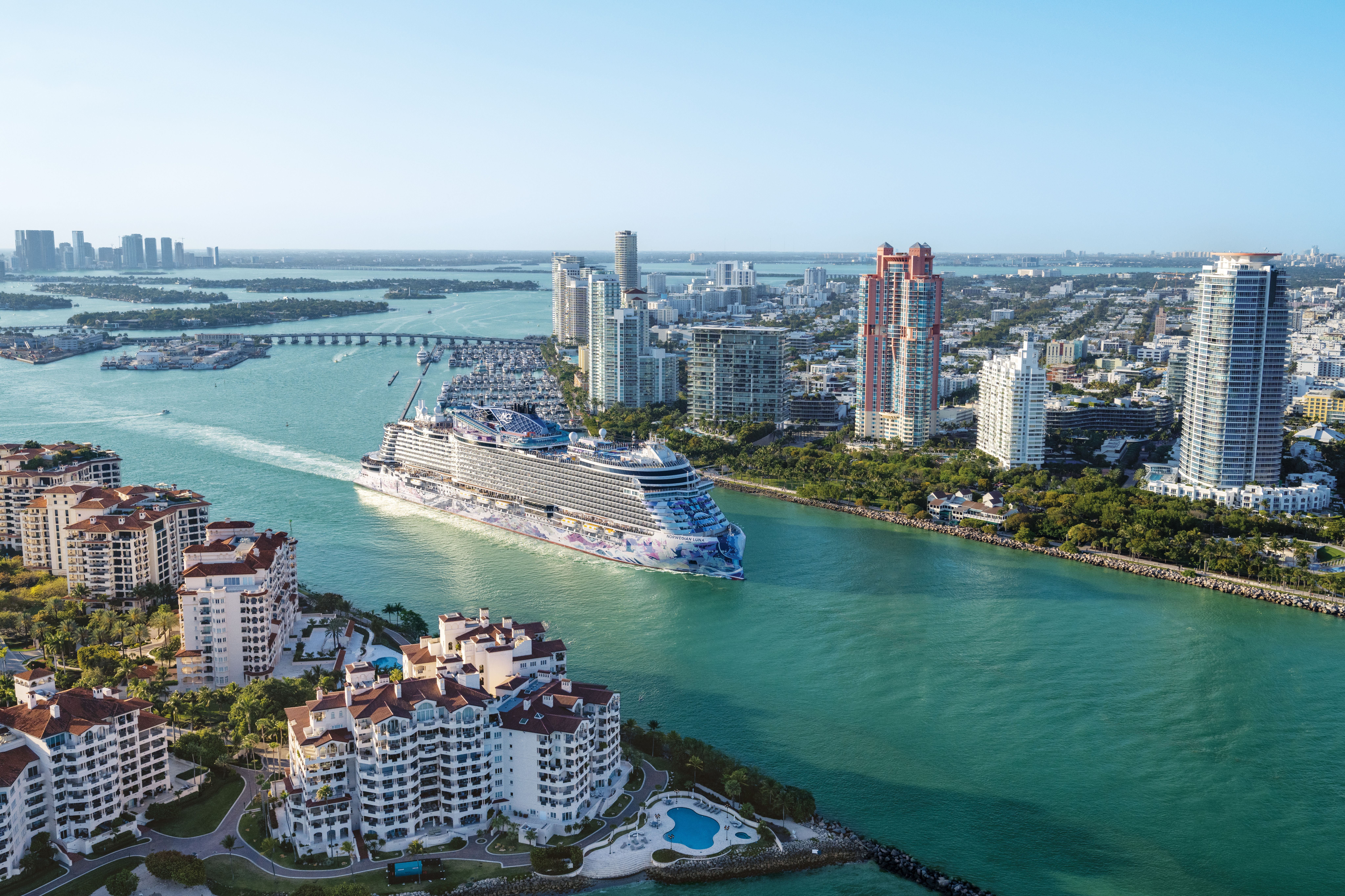 Cruise ship sailing past a city