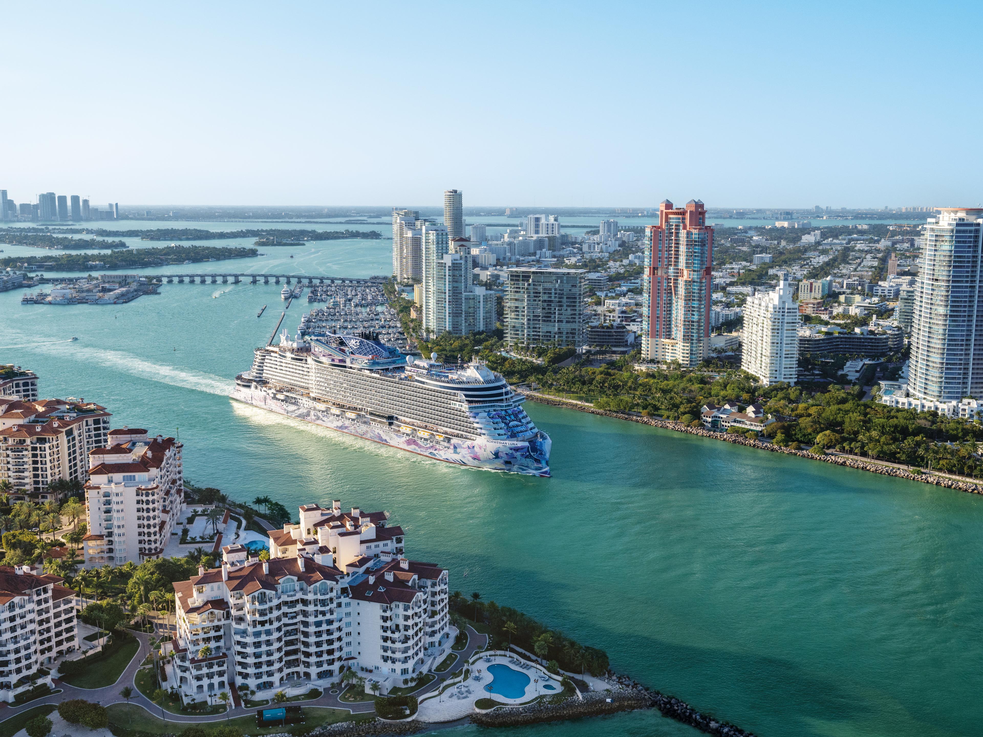 Cruise ship sailing past a city