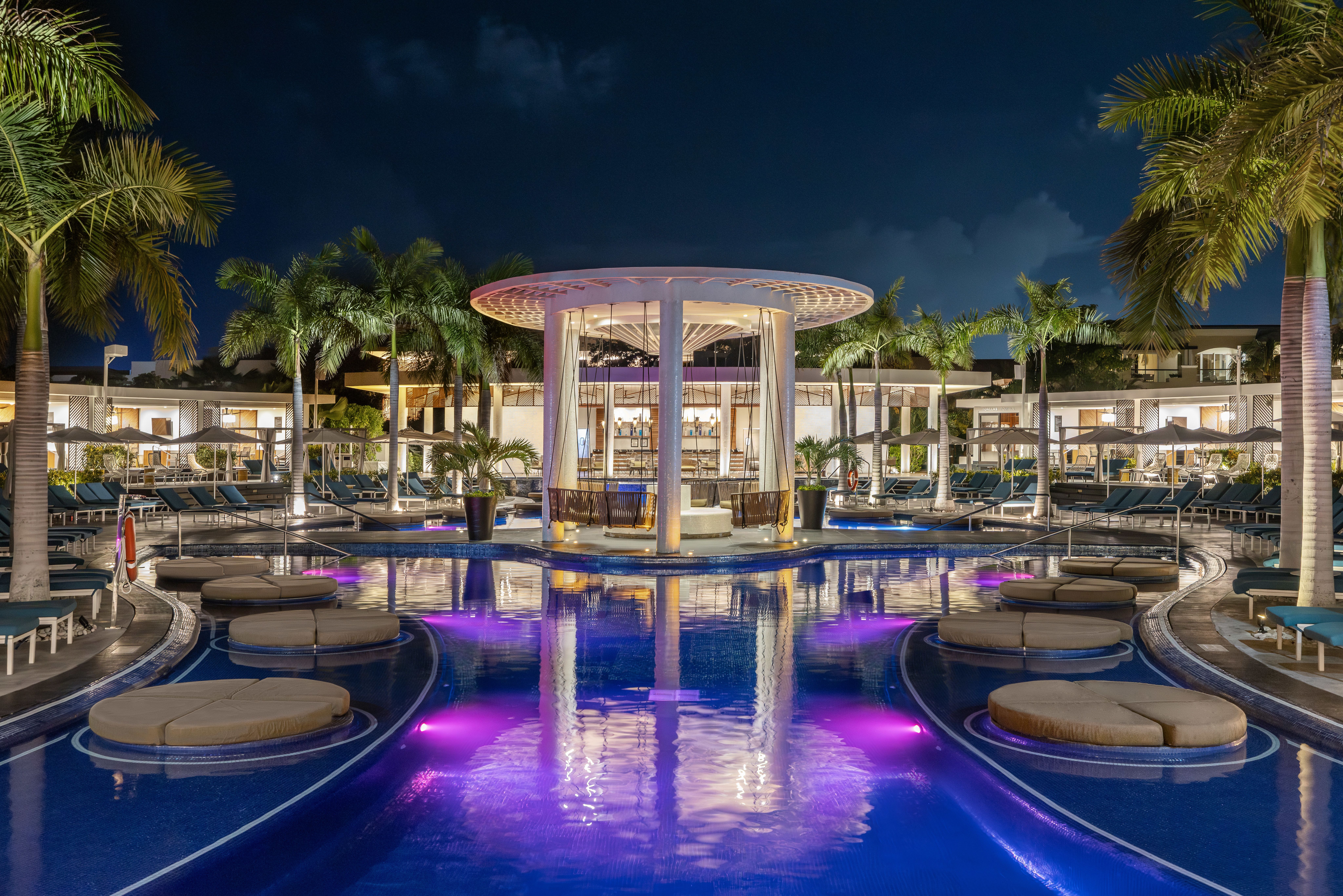 Evening view of lit swim up bars at resort