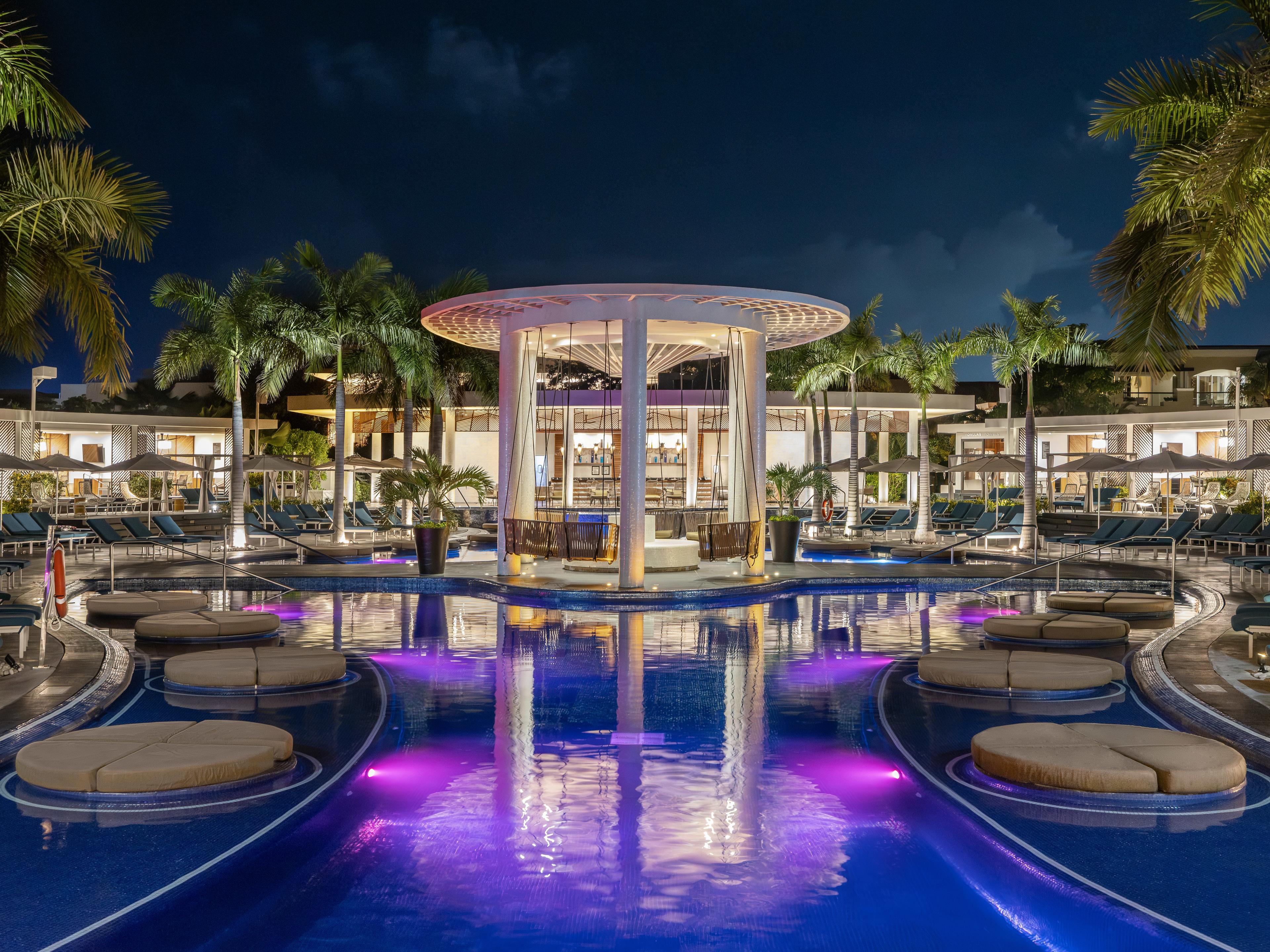 Evening view of lit swim up bars at resort