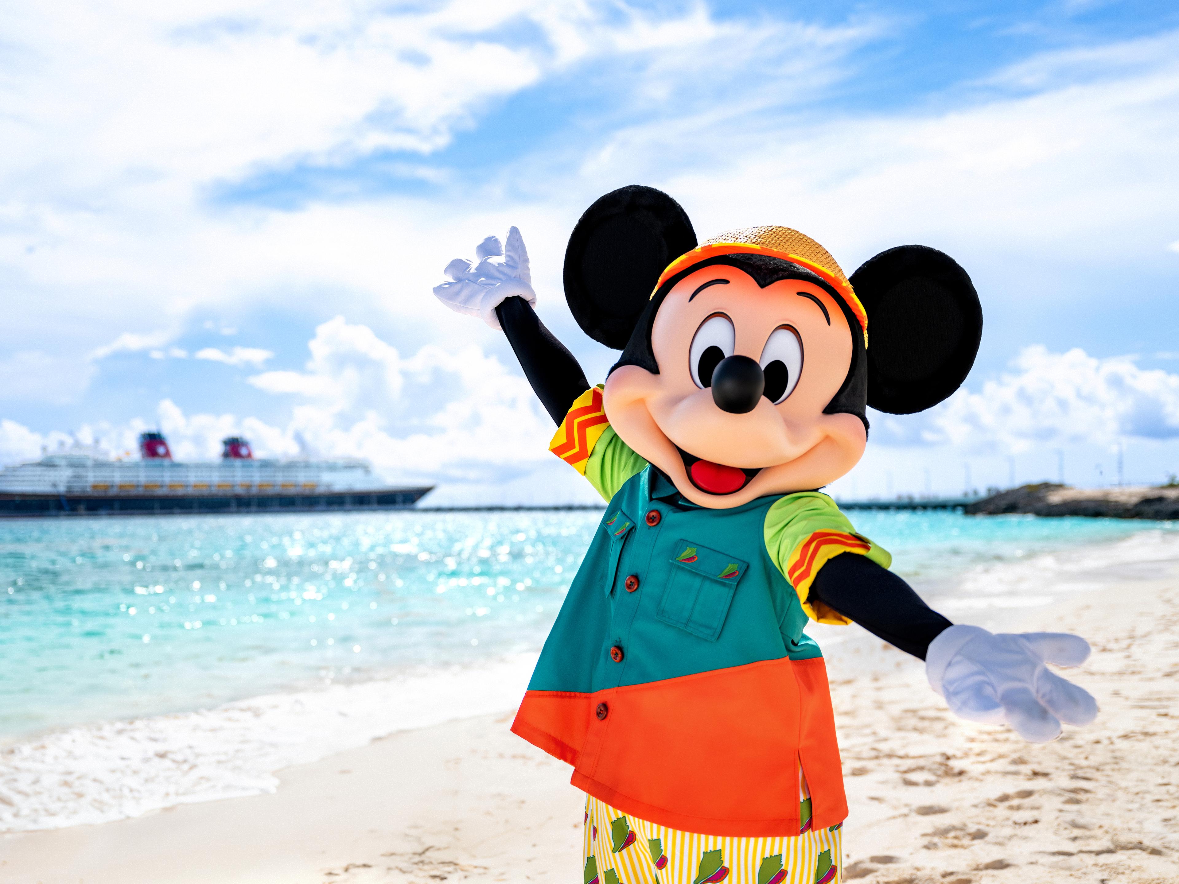 A Disney Cruise Line ship departing port at sunset