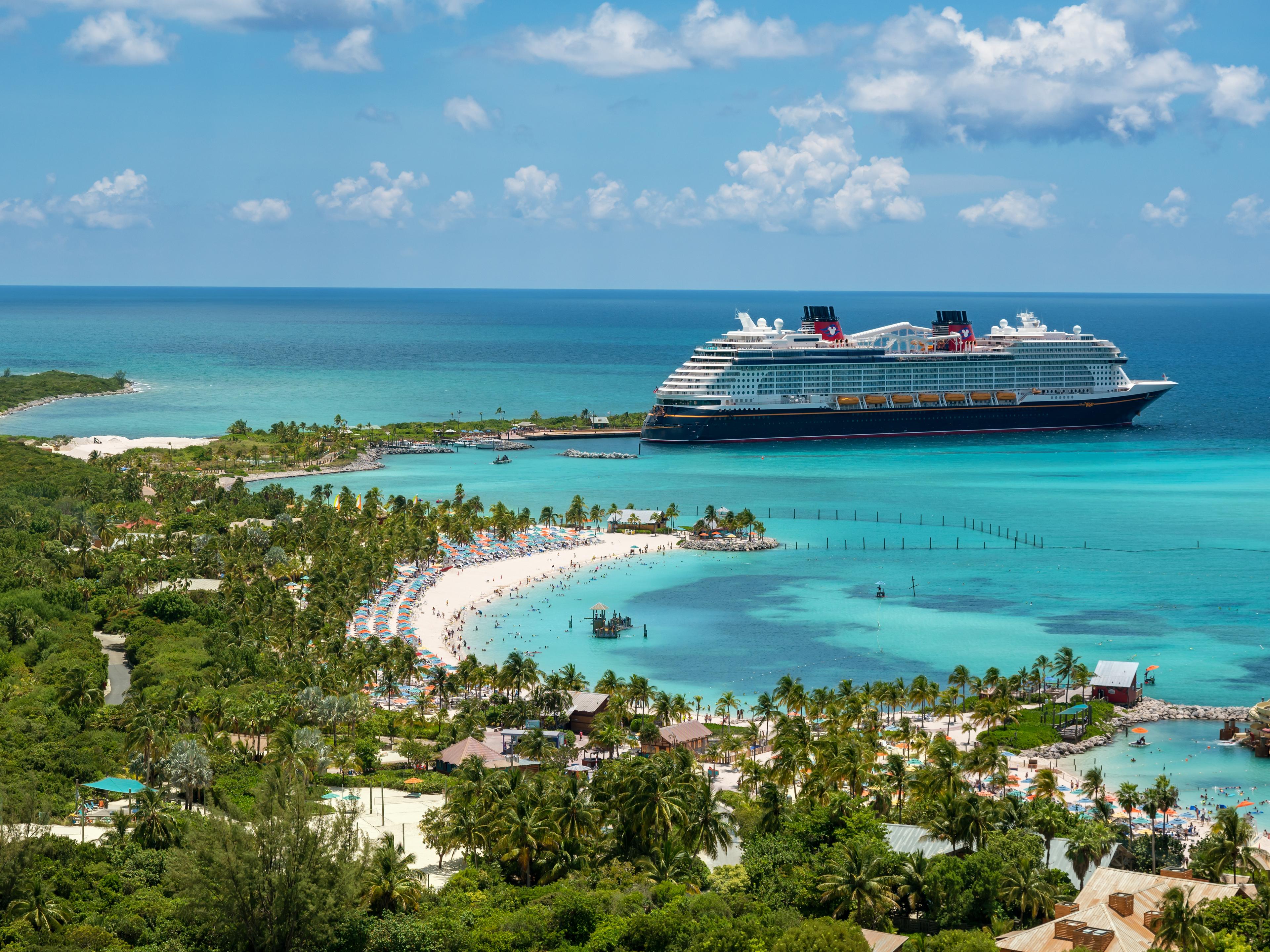 Bird's eye view of turquoise waters and a cruise ship at an island port