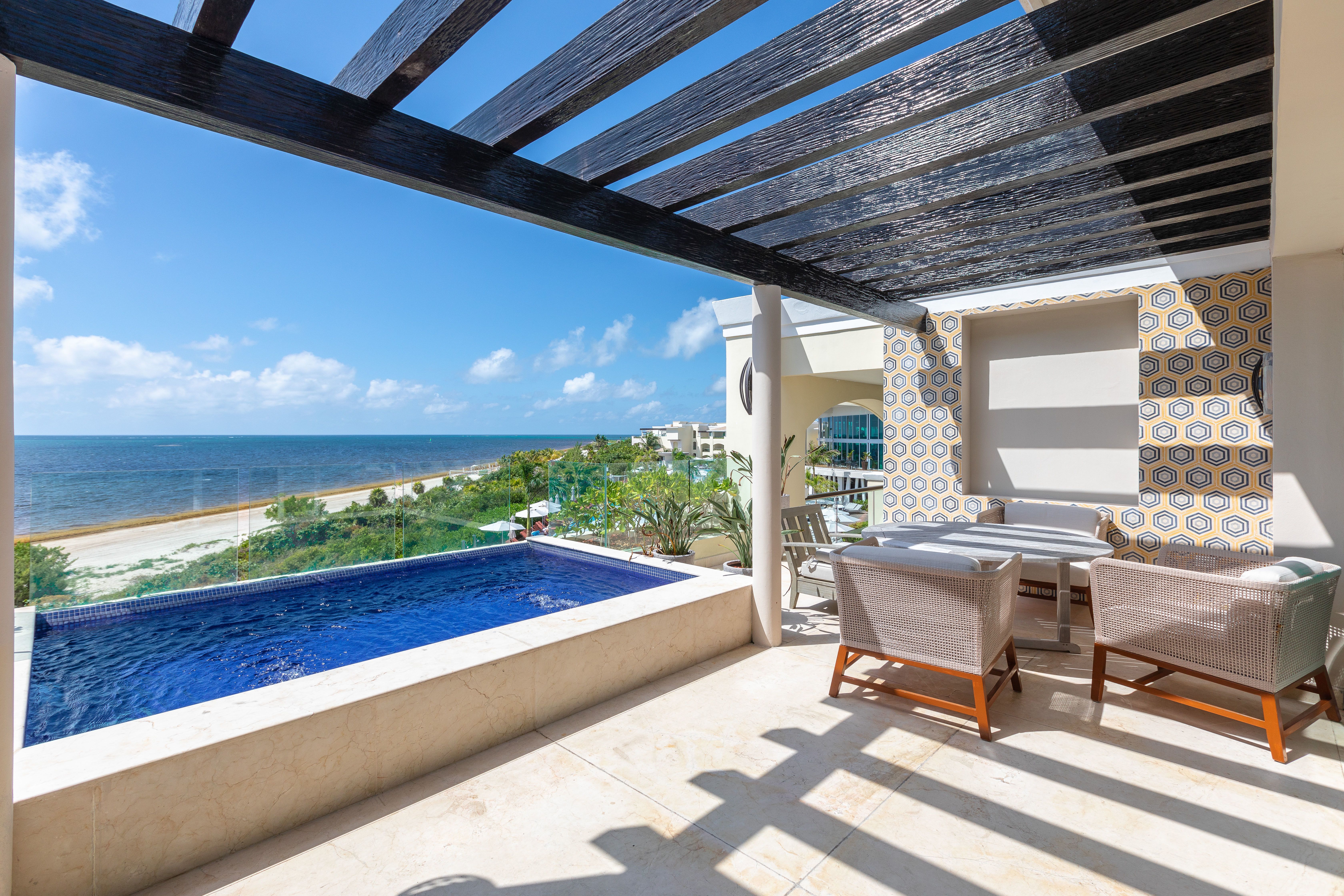 A private plunge pool and patio at a beach-front resort