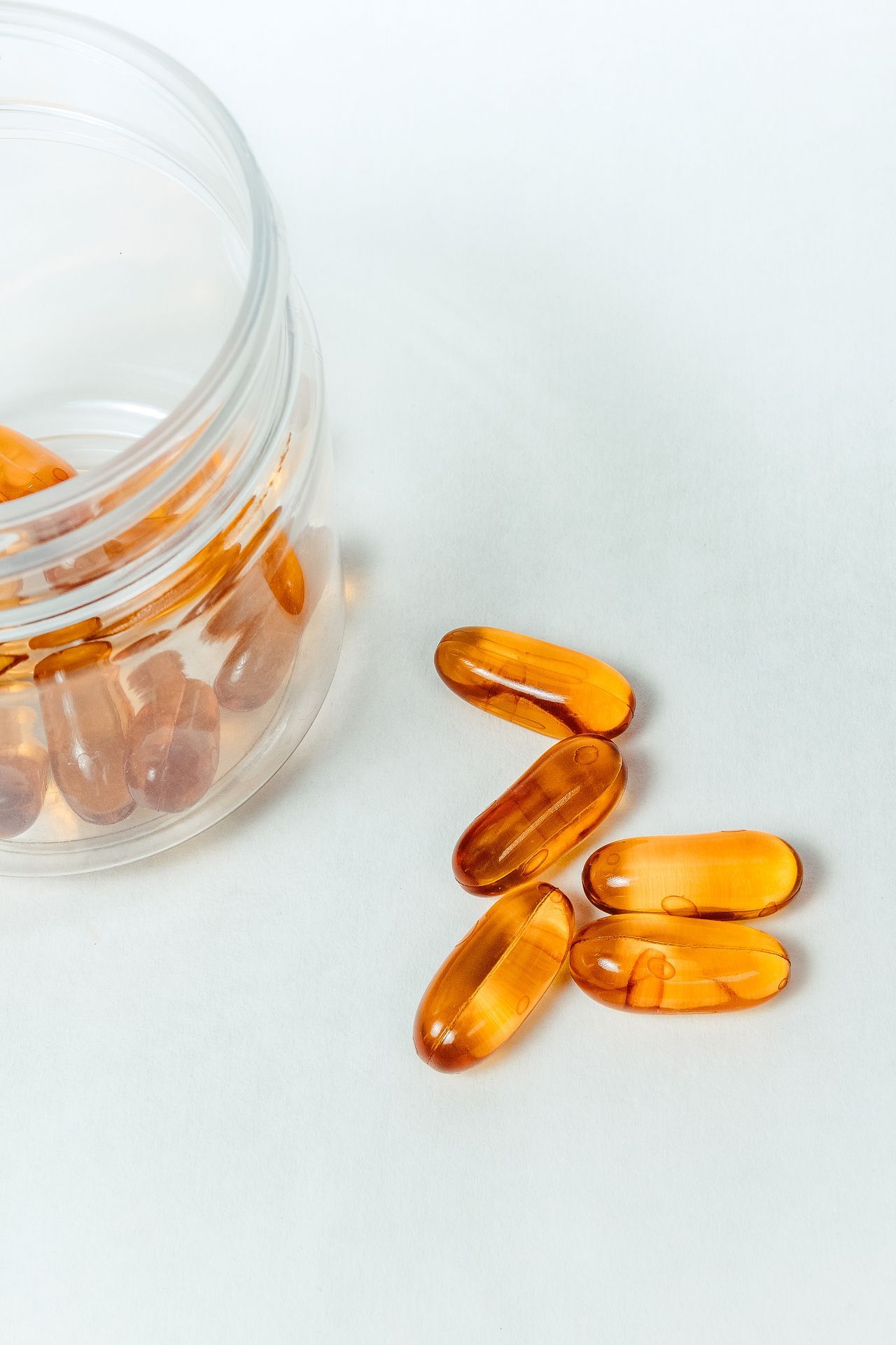 orange supplements in a glass container