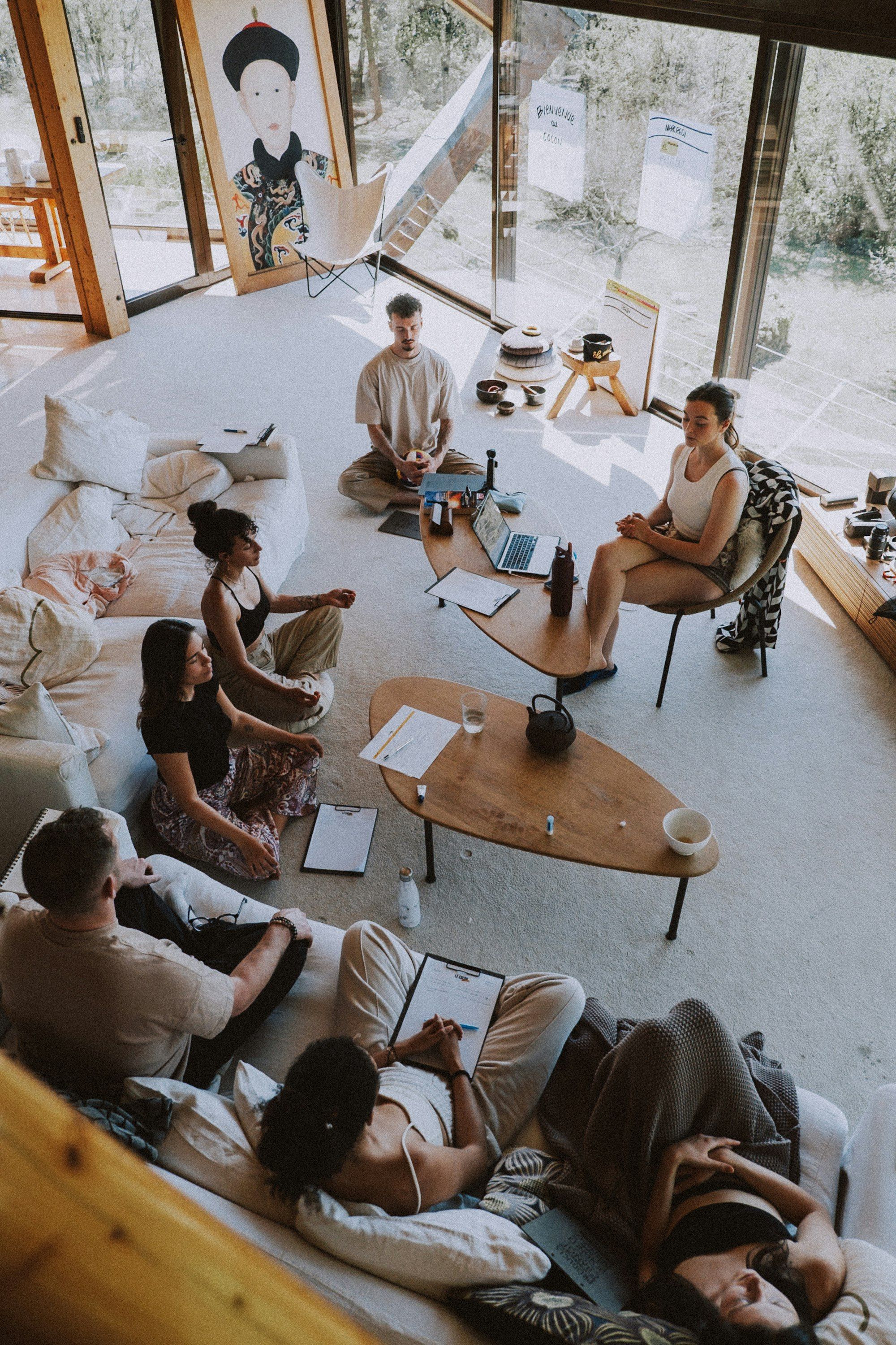 Group meditating together in a bright room