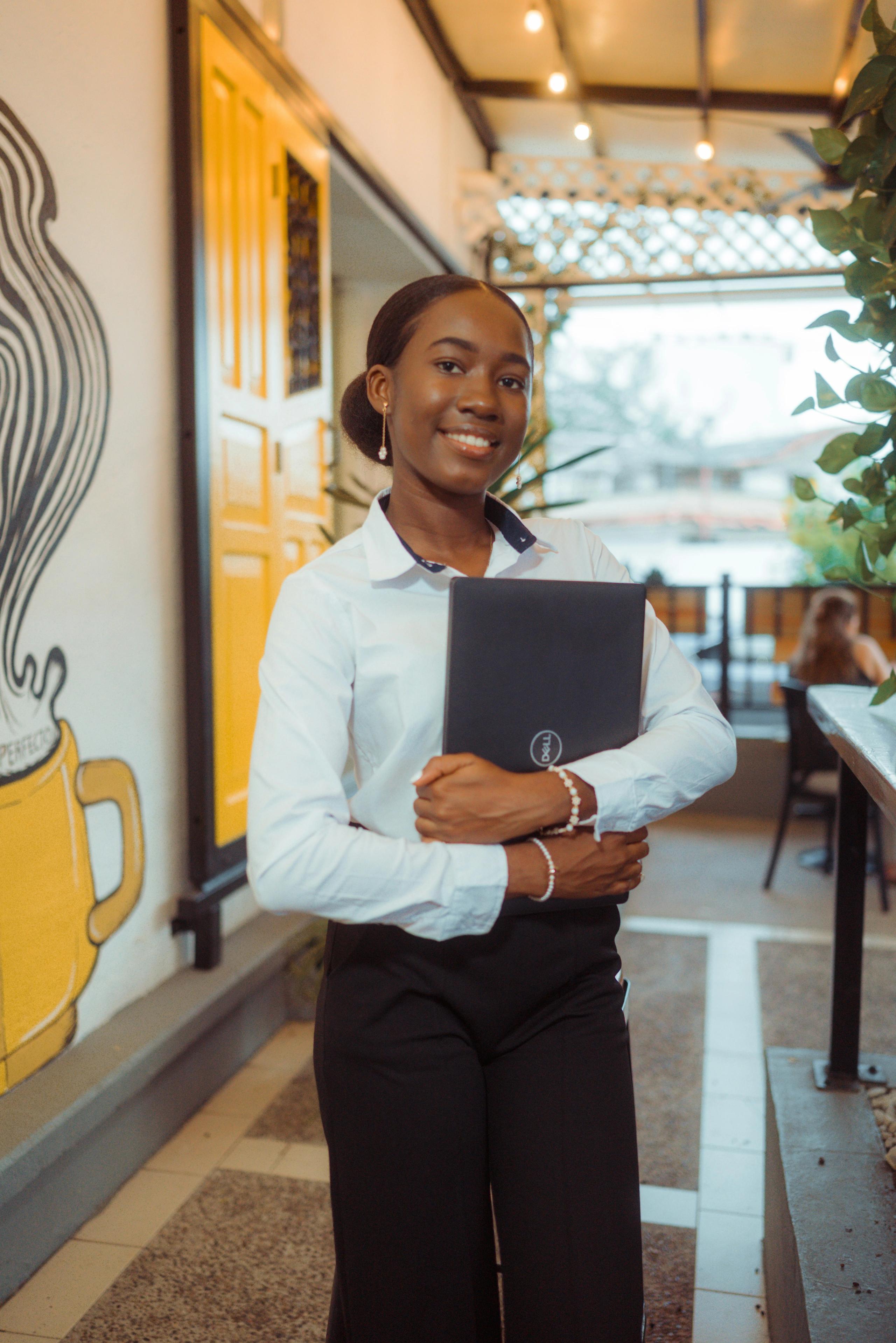 Young lady smiling holding a laptop
