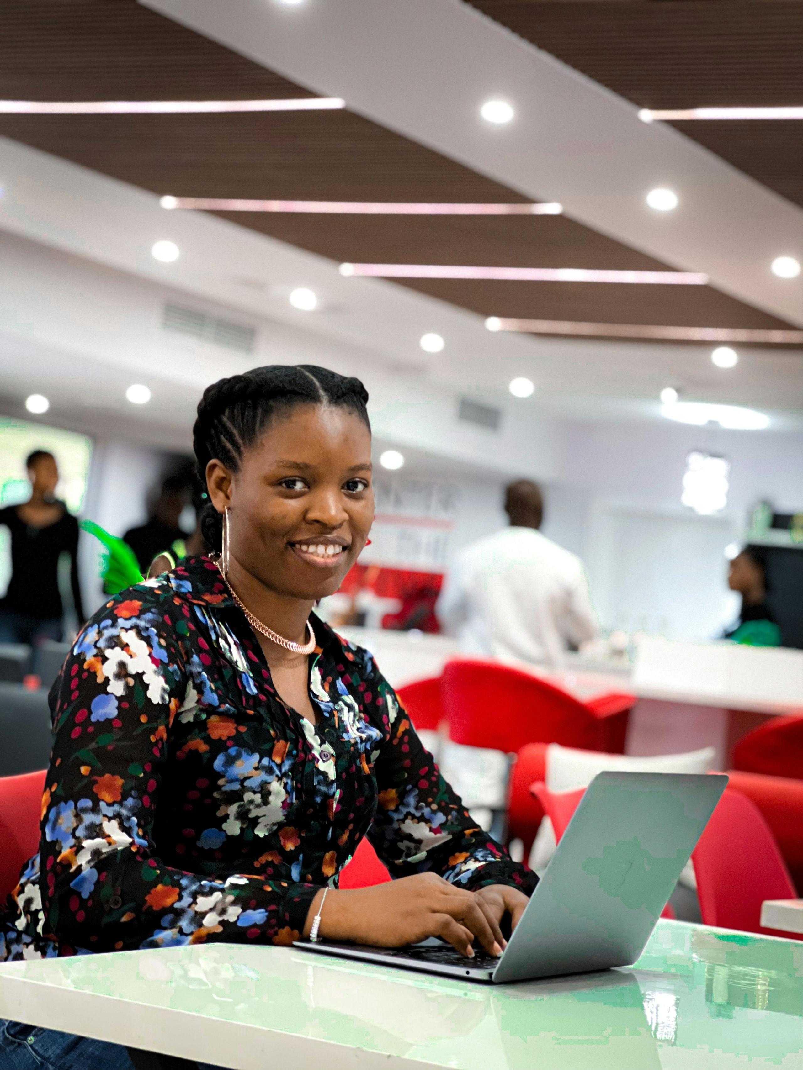 A Young Lady Smiling while one a laptop