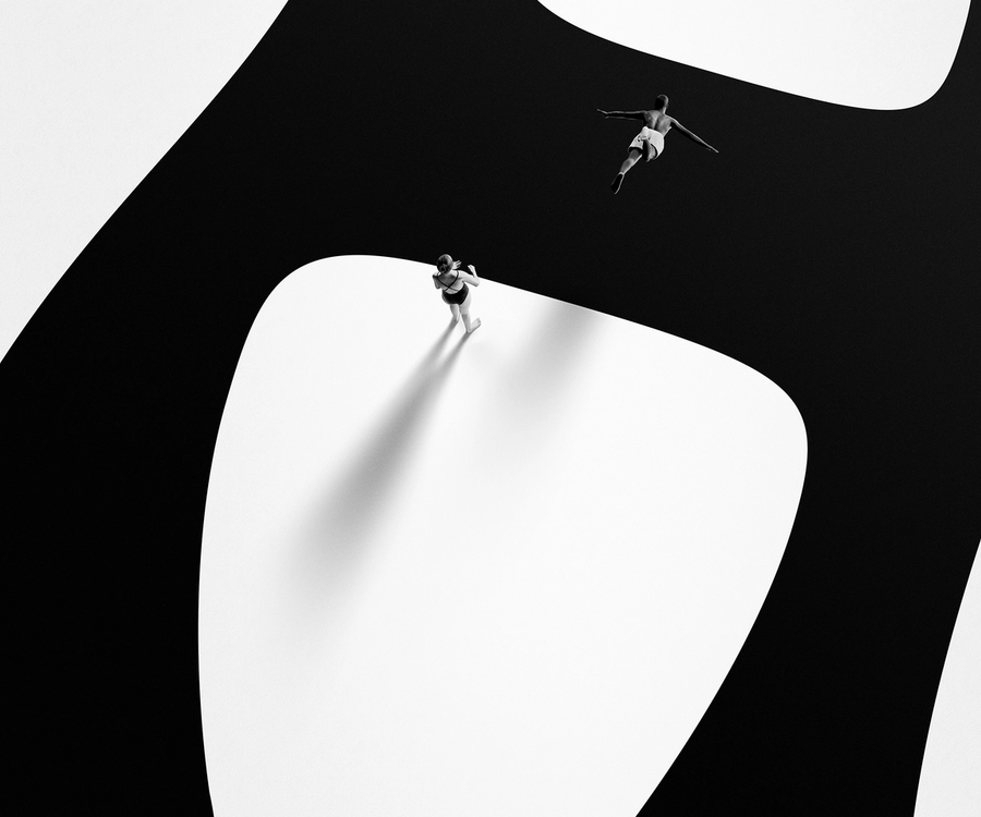 man jumping into a huge Helsingin Sanomat logo illustrated atop of black & white canvas