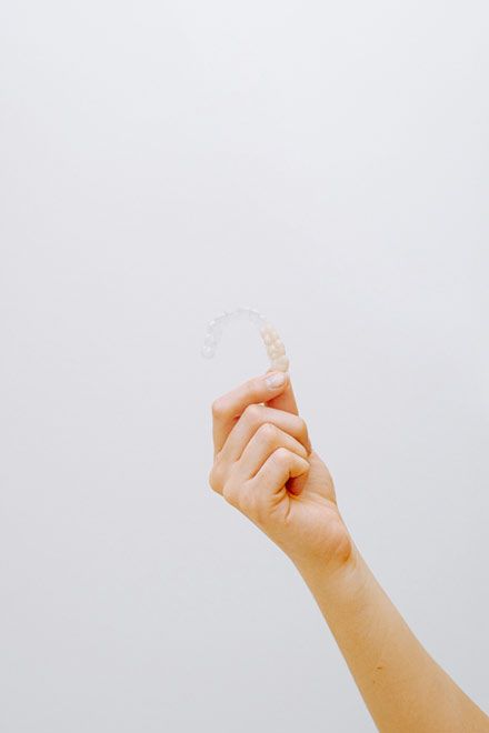 hand holding an Invisalign® clear aligner