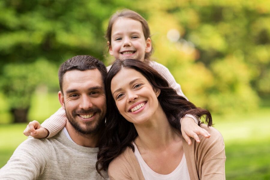 Happy family in park loves convenient, same day dental appointments in San Jose
