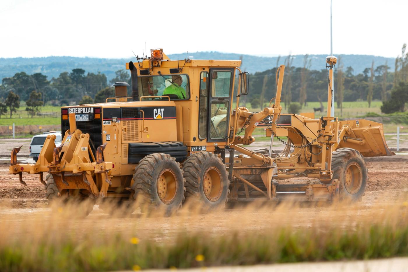 A Caterpillar grader working on a civil site