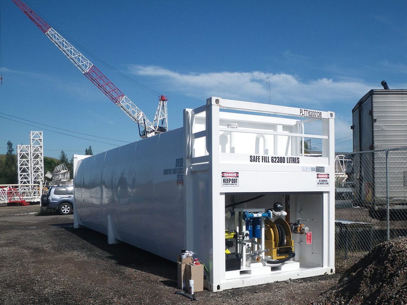 A containerised diesel tank with its pump bay open, showing the hose reel and pump