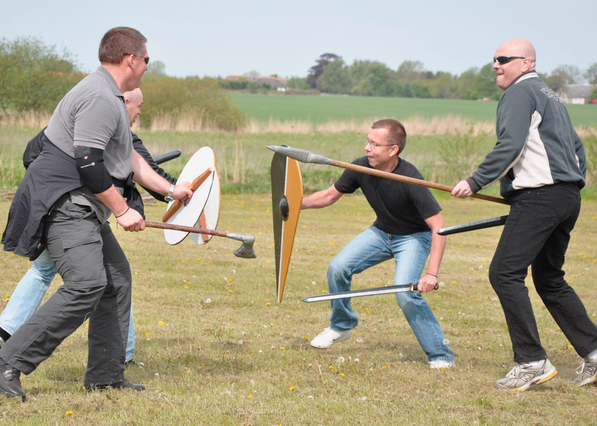 Four men battle with Viking weapons at a bachelor party in Trelleborg.