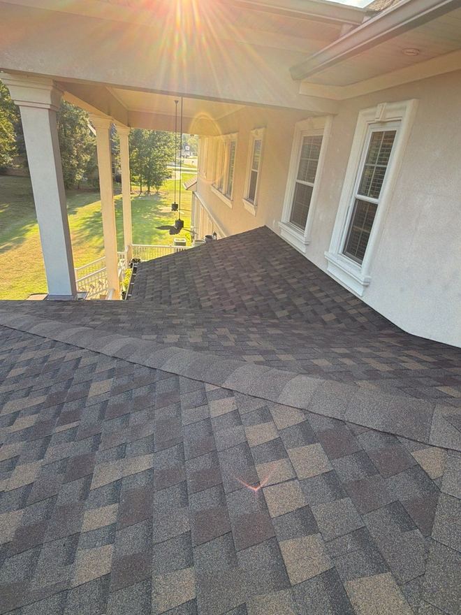 Late sun over a porch roof finished in blended shingles