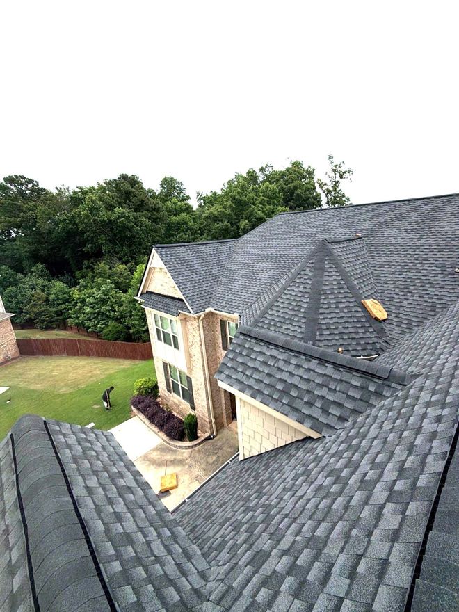Slate-grey shingles across a complex roof with several hips and valleys