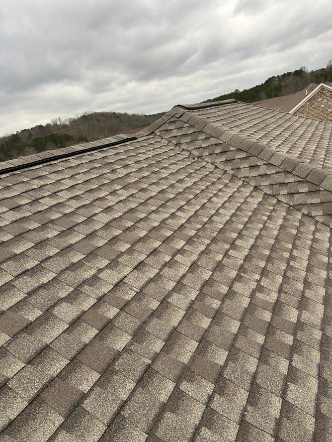 Wide expanse of new shingles running up to the ridge