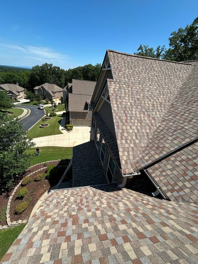 Blended multi-tone shingles on a large home overlooking a cul-de-sac