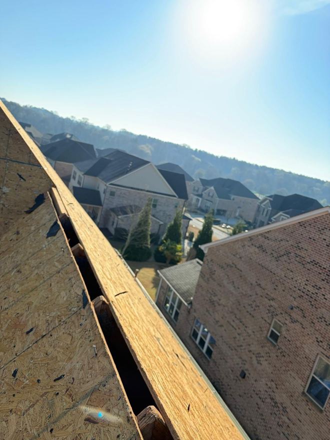 Exposed roof decking part-way through a replacement, subdivision beyond