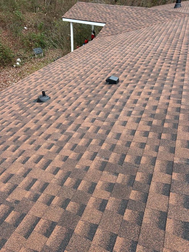 Weathered-wood-tone shingles with new pipe boot flashings