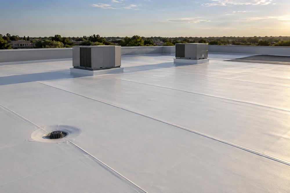 White TPO membrane roof on a low-rise commercial building with rooftop HVAC units