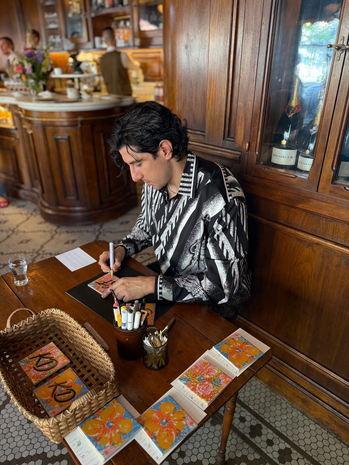 Rodolfo writing calligraphy in a boutique setting