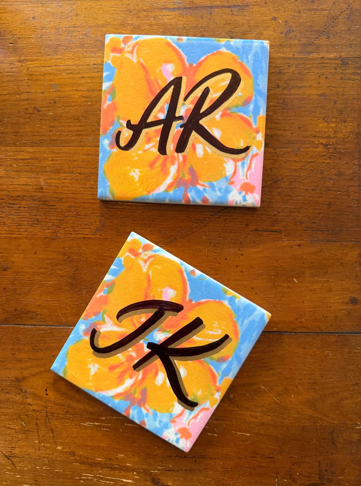 Expressive hand-lettered initials with colorful artwork