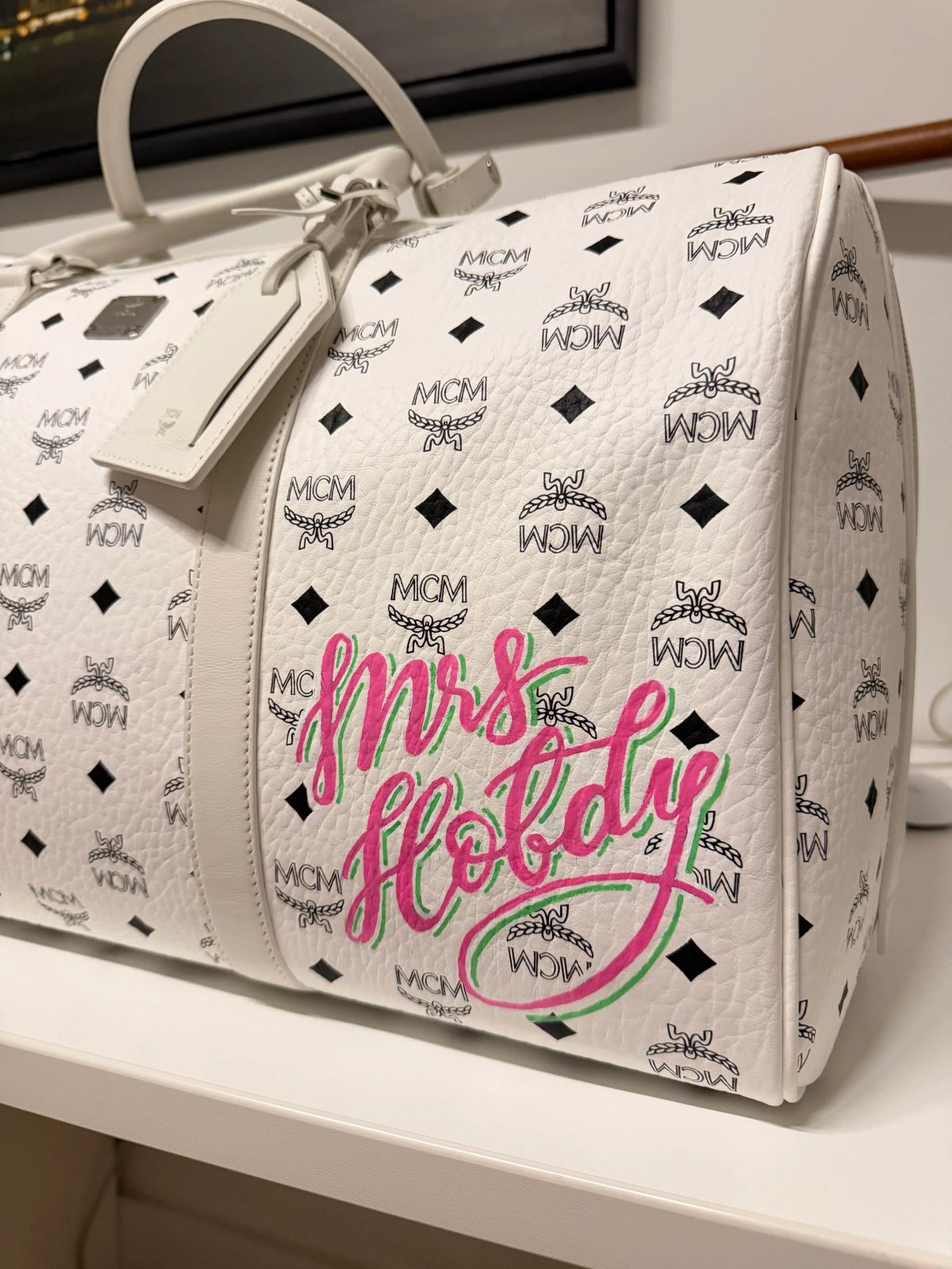 Hand-painted lettering and motifs on leather goods