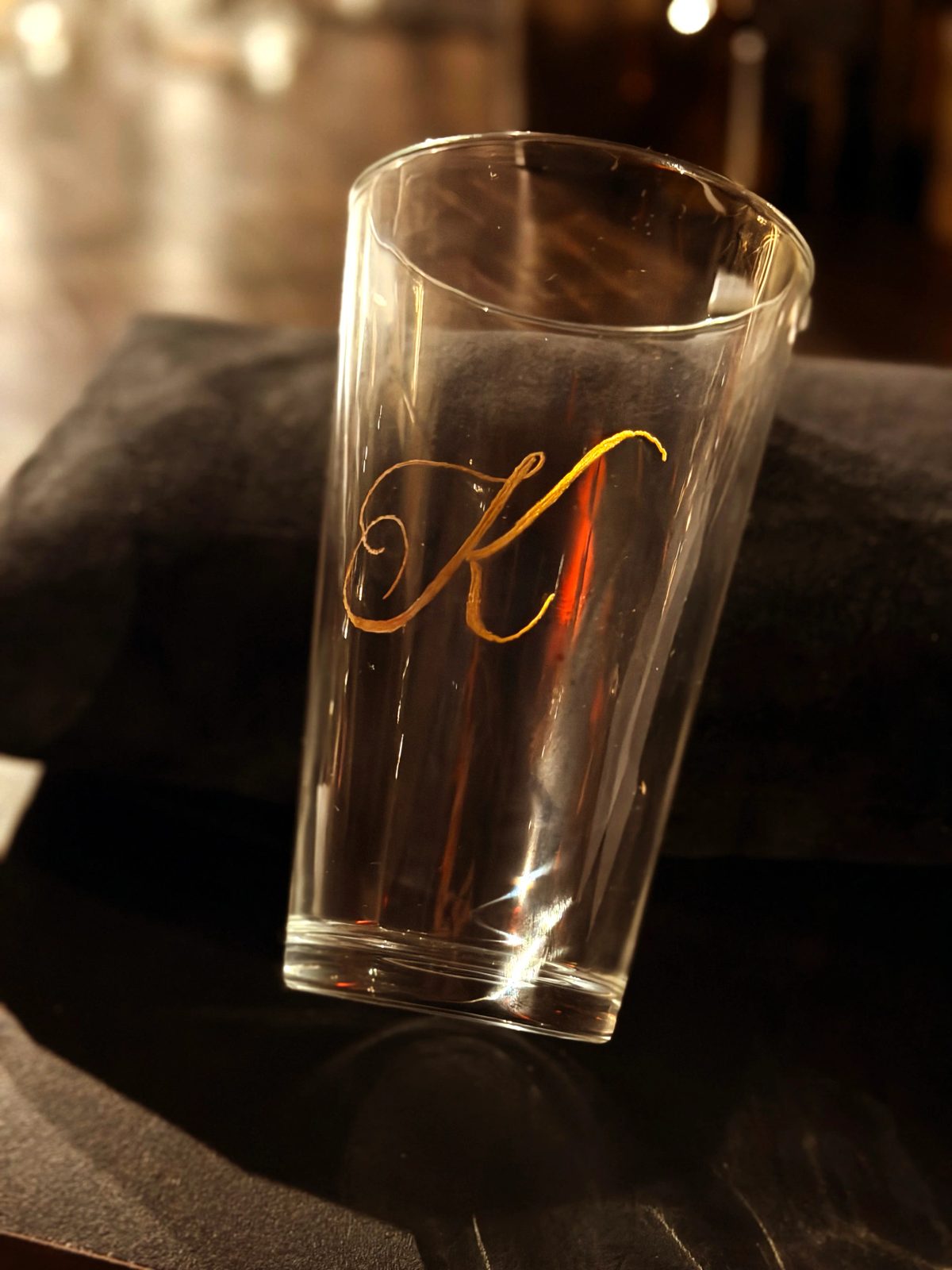 Hand-engraved lettering on a drinking glass