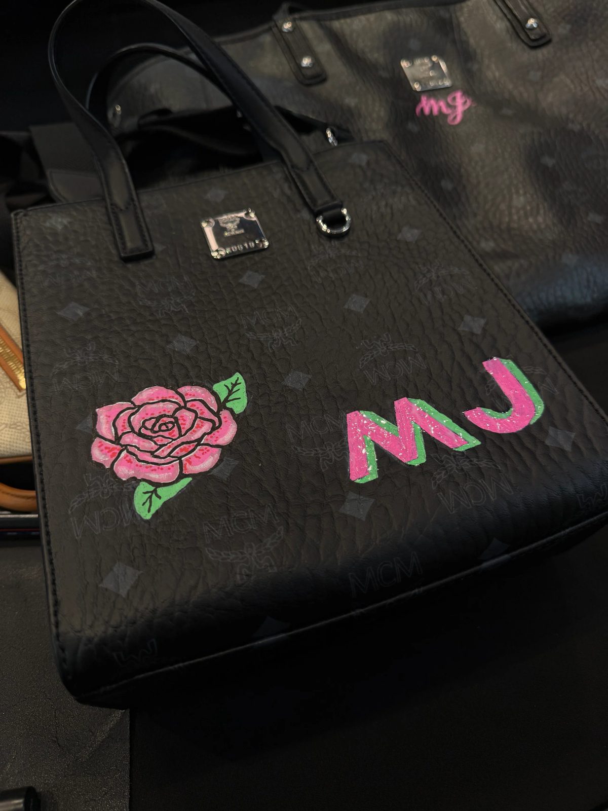 Hand-painted lettering and motifs on leather goods