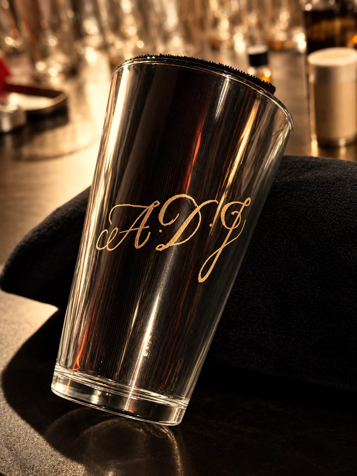 Hand-engraved lettering on a drinking glass