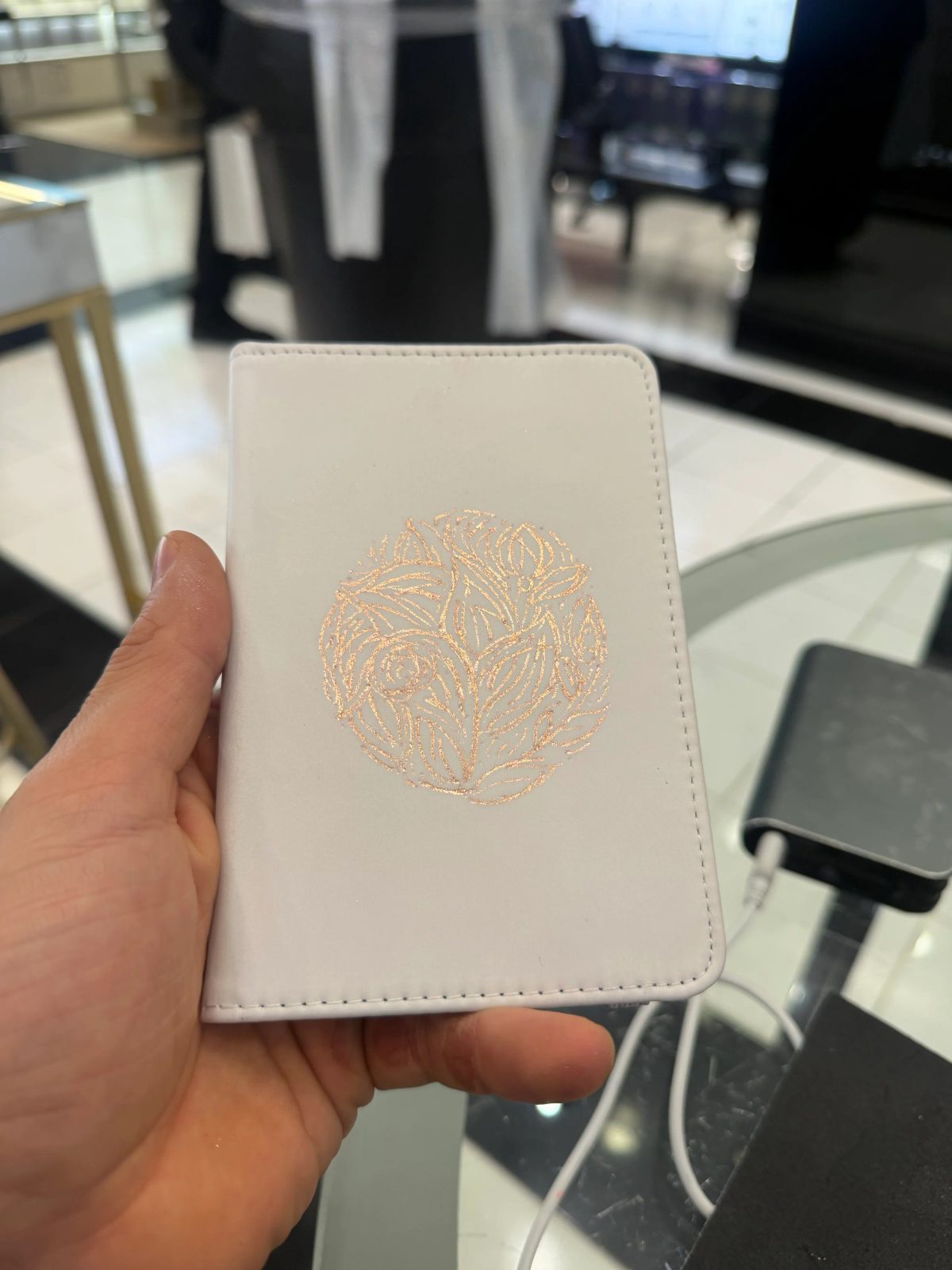 Fine architectural and botanical illustration on a small white notebook