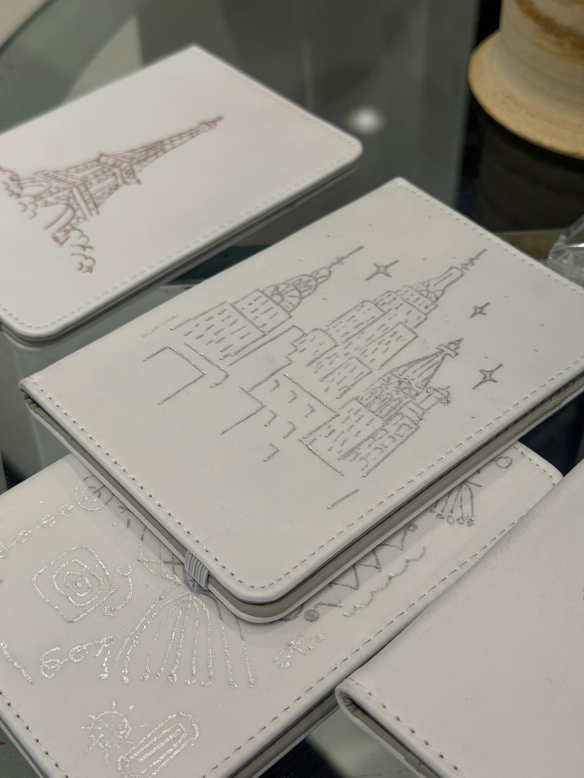 Fine architectural and botanical illustration on a small white notebook